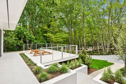 a view of a swimming pool with a garden and trees