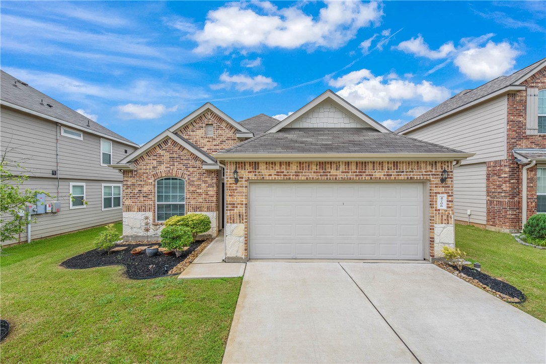 View of front of property featuring driveway, an a