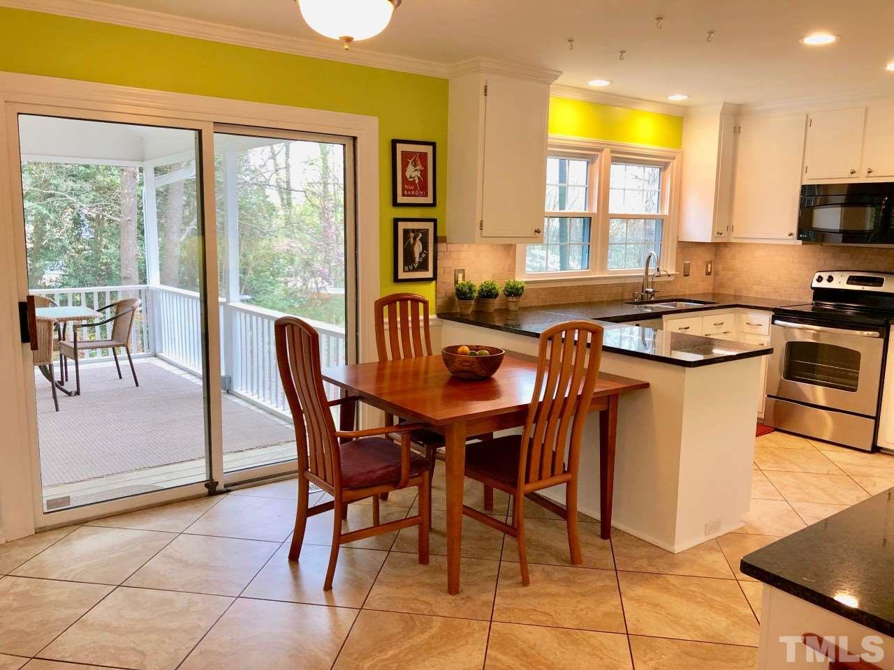 5412 Fairoaks Road Durham, NC 27712 - Photo 11 of 25 a dining hall with stainless steel appliances a stove a sink a dining table and chairs