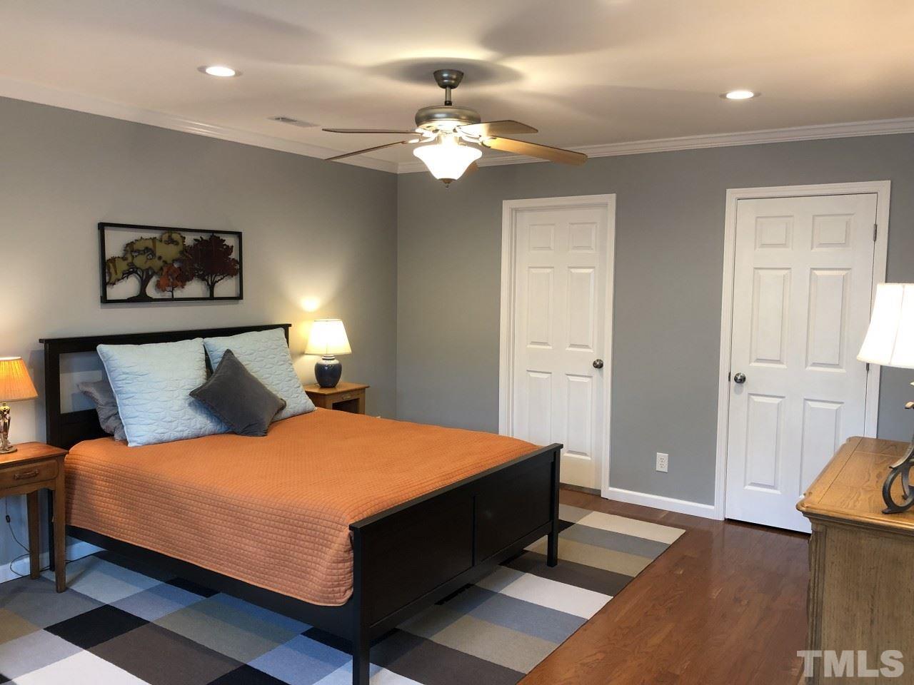 5412 Fairoaks Road Durham, NC 27712 - Photo 15 of 25 a bedroom with a bed and a chandelier