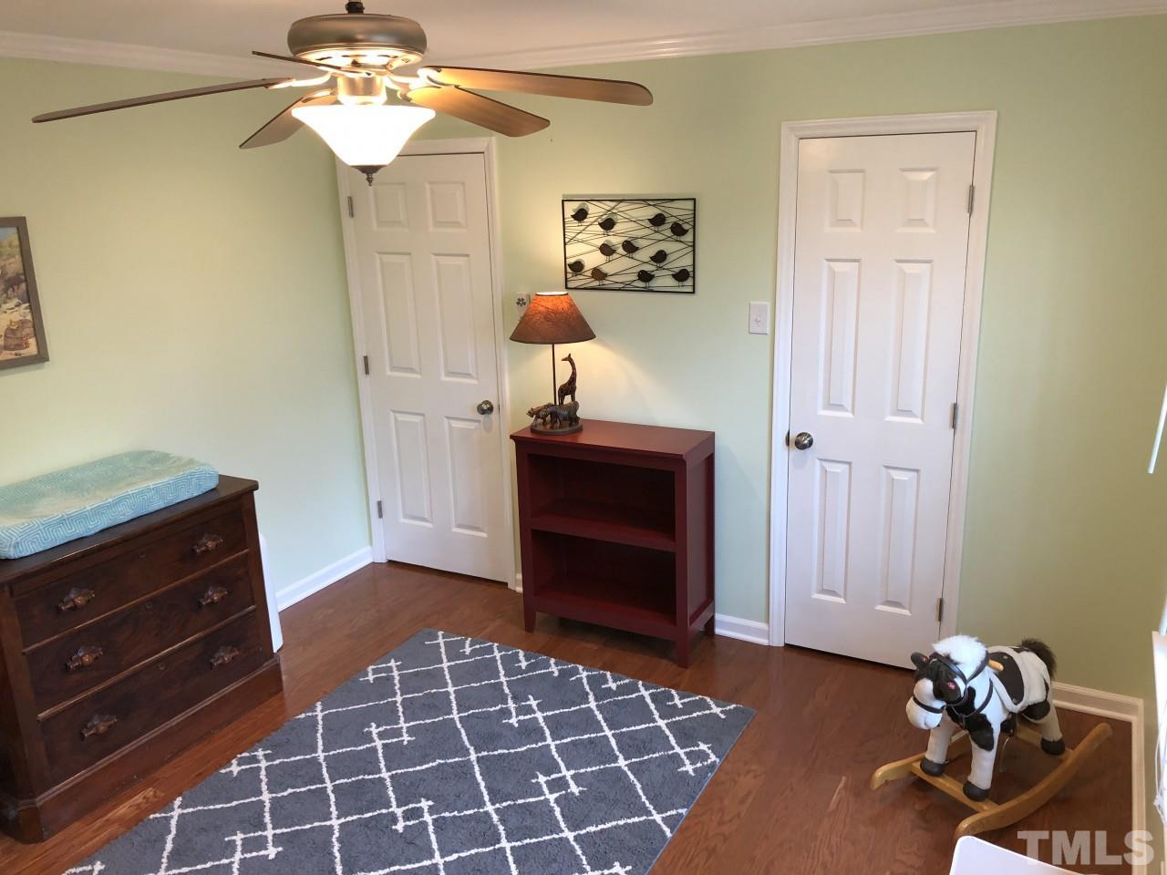 5412 Fairoaks Road Durham, NC 27712 - Photo 17 of 25 a bedroom with a bed and a dresser in it