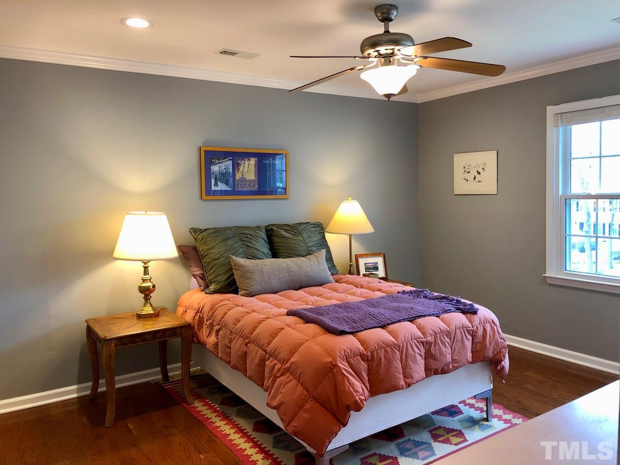 5412 Fairoaks Road Durham, NC 27712 - Photo 19 of 25 a bedroom with a bed and a lamp