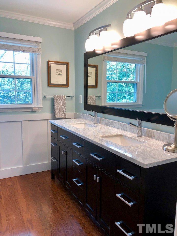 5412 Fairoaks Road Durham, NC 27712 - Photo 20 of 25 a bathroom with a granite countertop sink and a large mirror