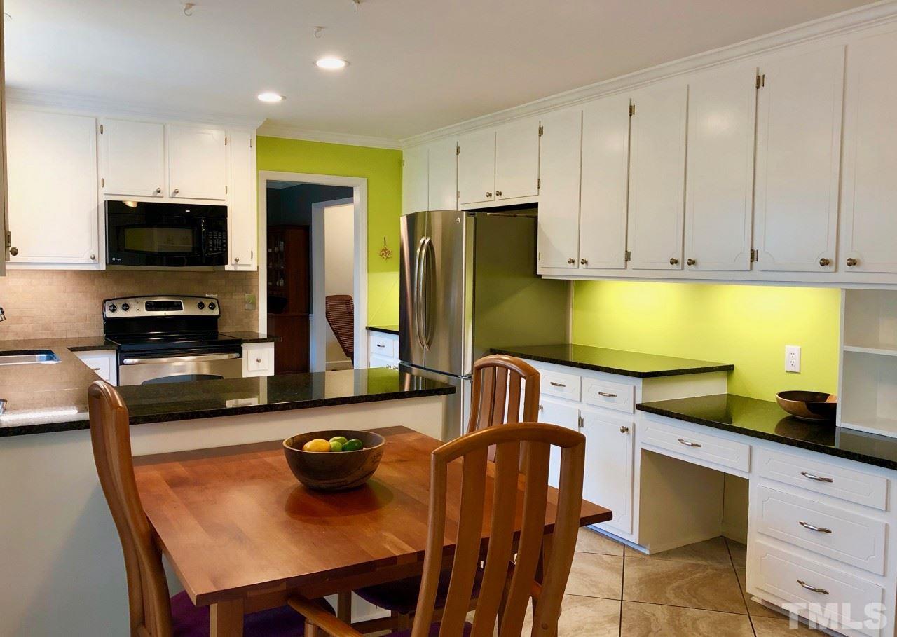 5412 Fairoaks Road Durham, NC 27712 - Photo 10 of 25 a kitchen with stainless steel appliances a stove a sink a microwave a refrigerator and cabinets