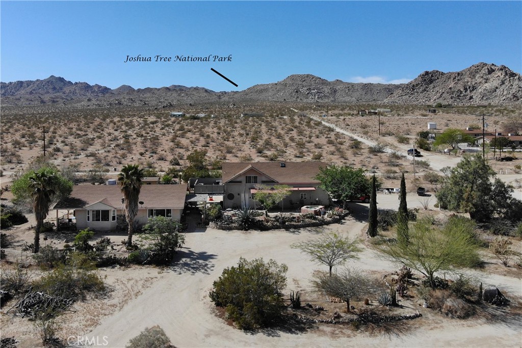 6875 Sunkist Road Joshua Tree, CA 92252 - Photo 1 of 1 a view of a town with mountains in the background
