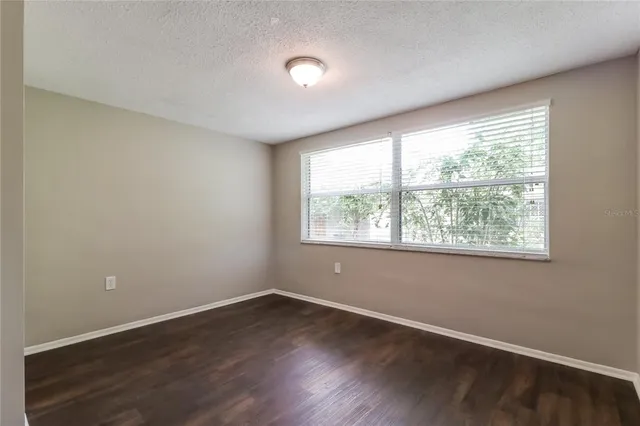 an empty room with wooden floor and closet