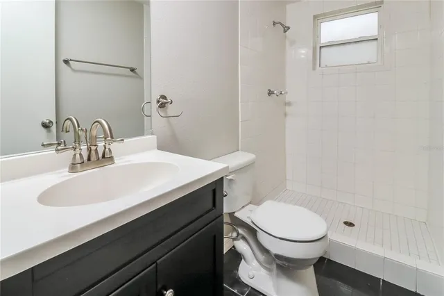 a front view of a house with a yard and potted plants