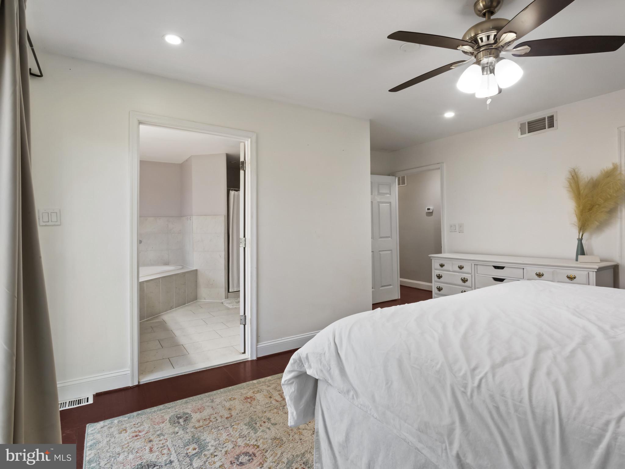 1371 Dicus Mill Road Severn, MD 21144 - Photo 13 of 35 a large white bed in a white room