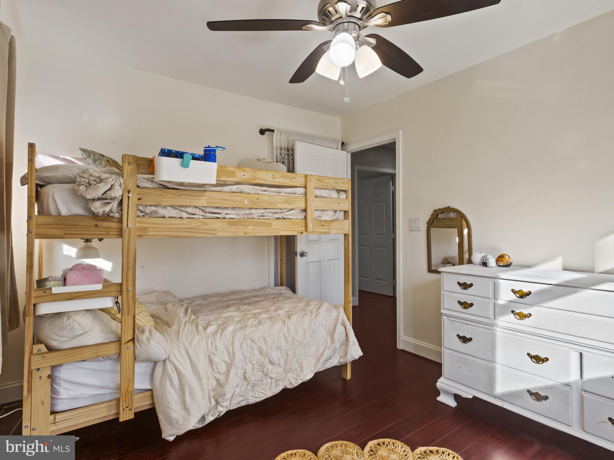 1371 Dicus Mill Road Severn, MD 21144 - Photo 16 of 35 a bedroom with a bed and a chandelier