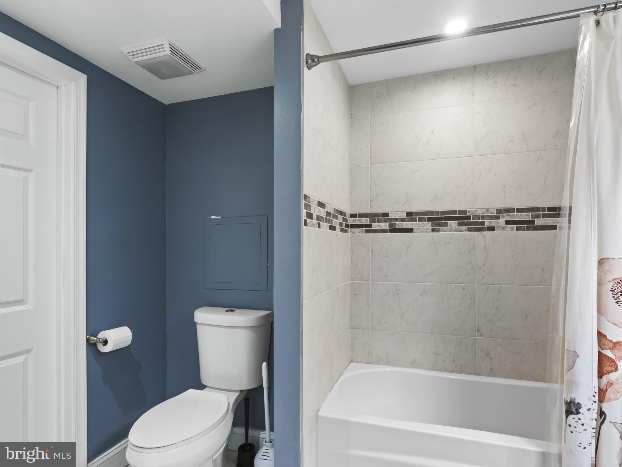 1371 Dicus Mill Road Severn, MD 21144 - Photo 21 of 35 a bathroom with a shower a toilet and bathtub