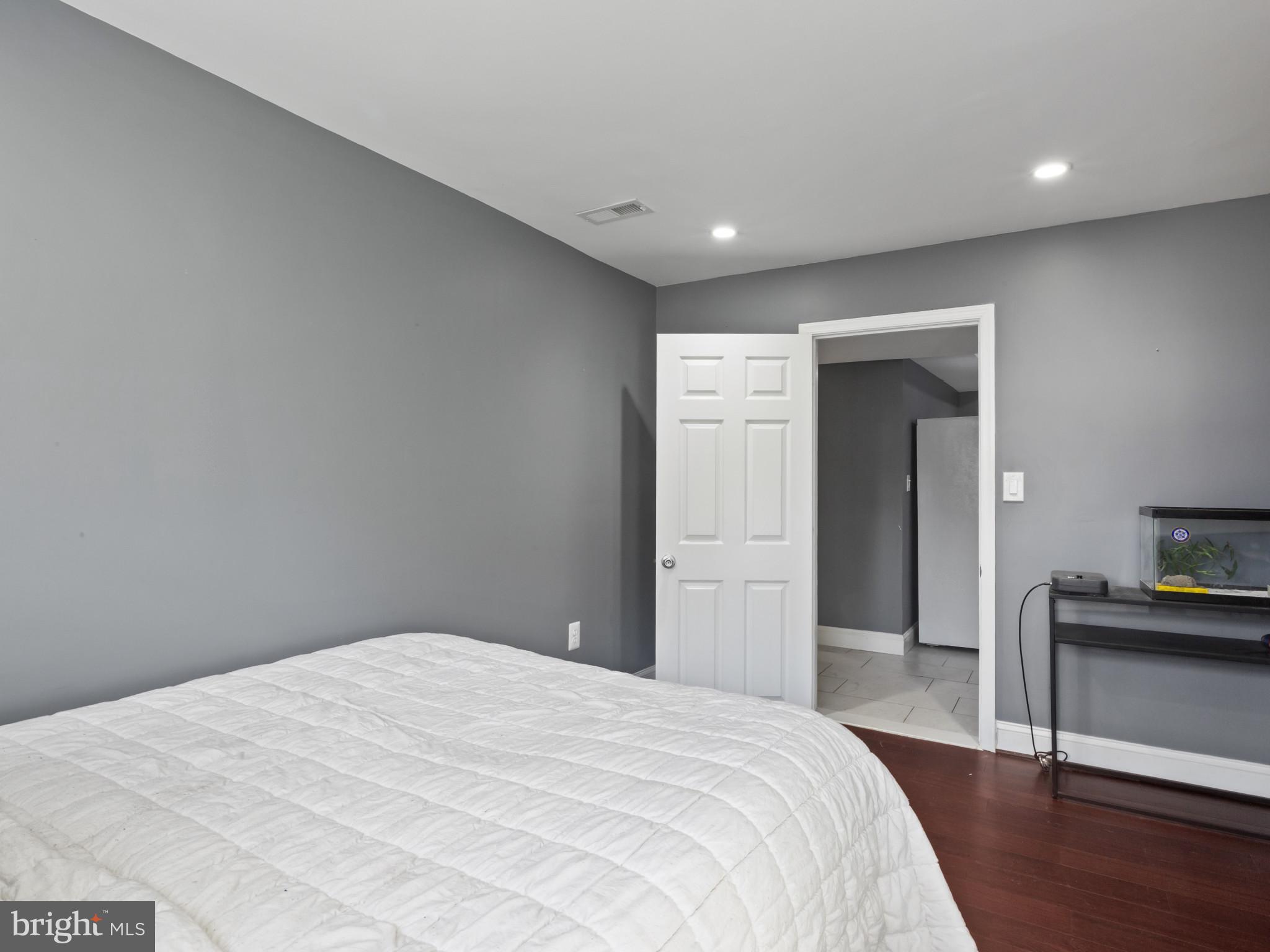 1371 Dicus Mill Road Severn, MD 21144 - Photo 27 of 35 a bedroom with a bed and wooden floor