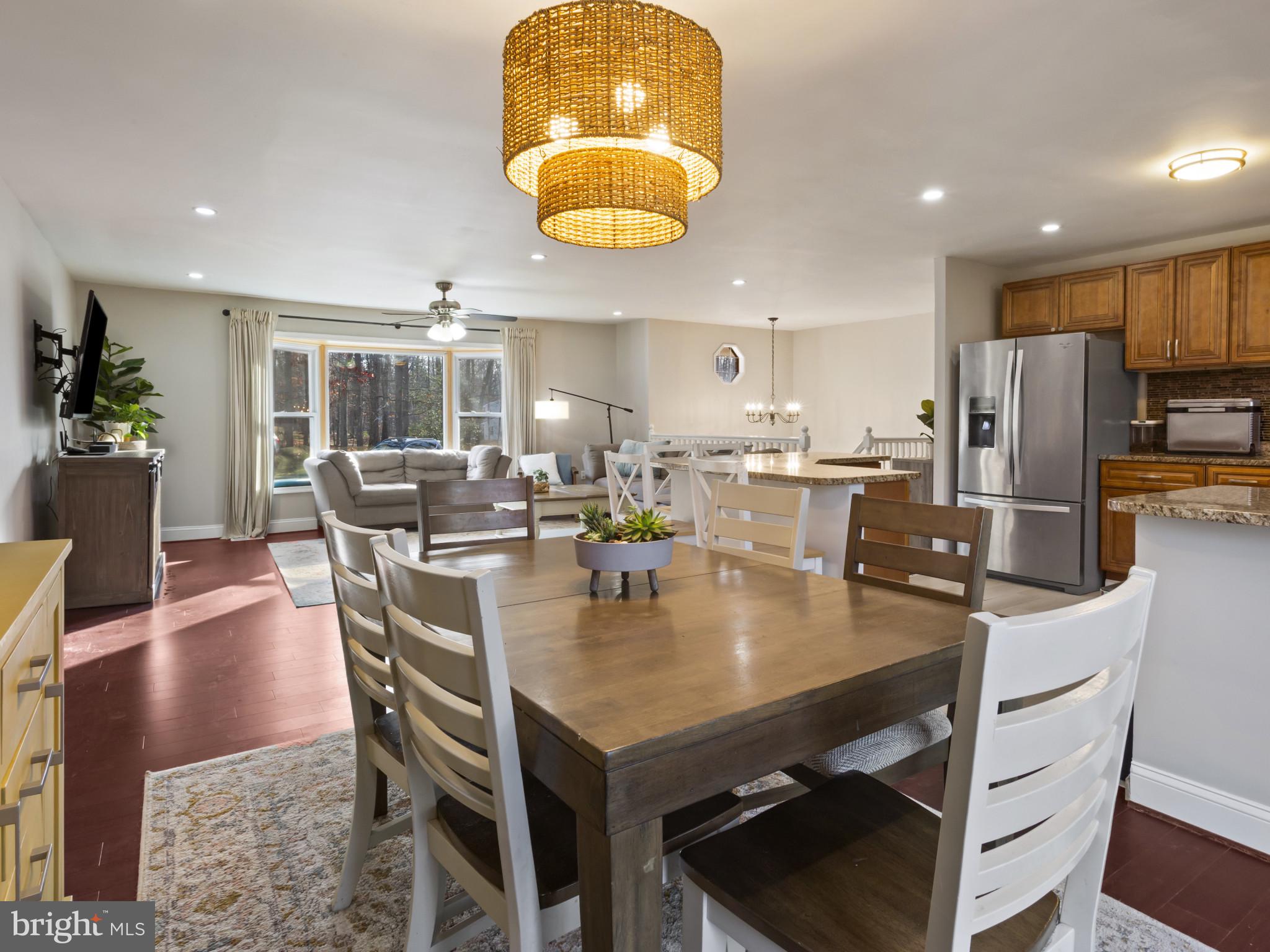 1371 Dicus Mill Road Severn, MD 21144 - Photo 9 of 35 a kitchen with a dining table chairs and refrigerator