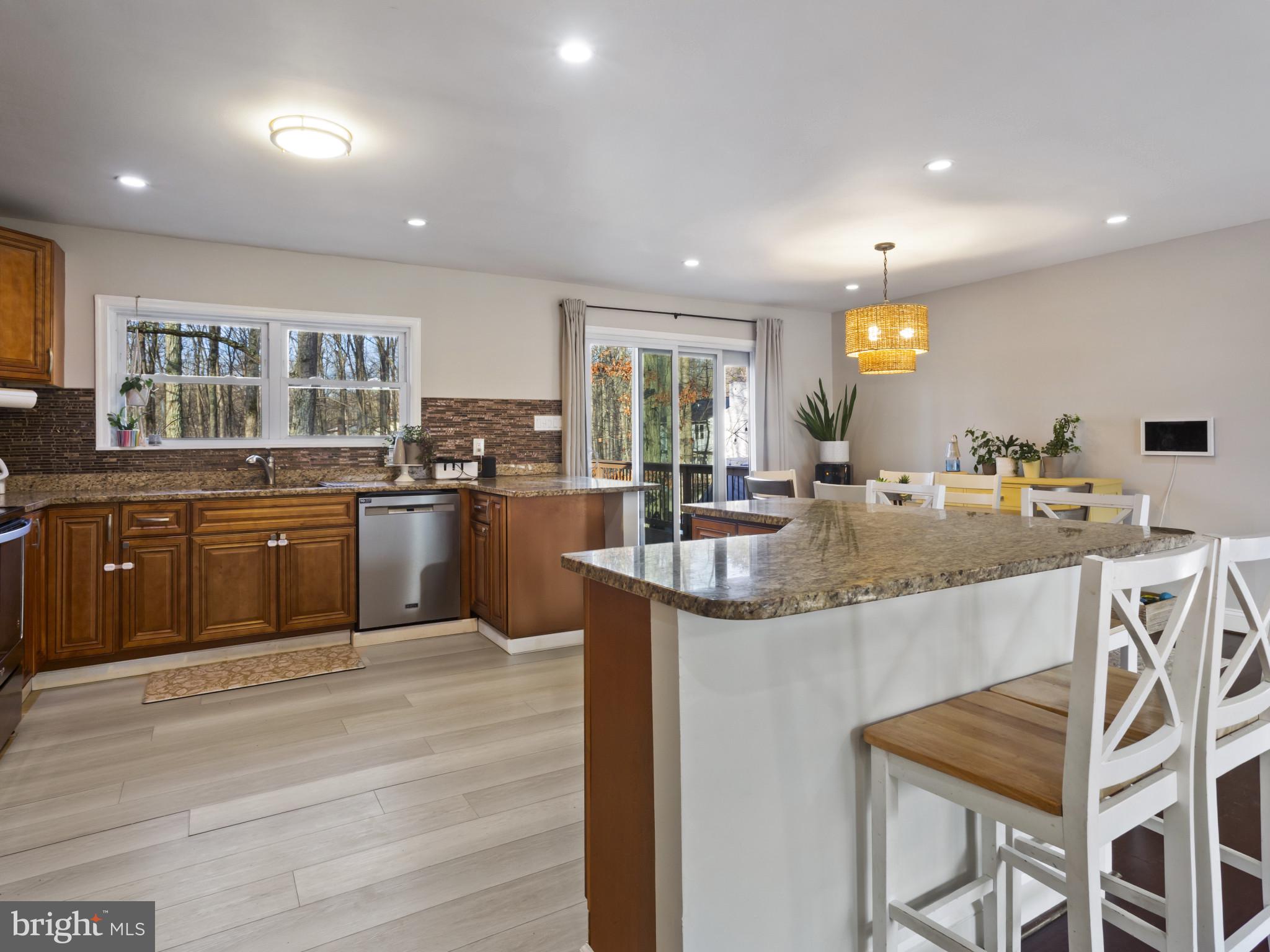 1371 Dicus Mill Road Severn, MD 21144 - Photo 10 of 35 a kitchen with kitchen island granite countertop wooden cabinets and counter space