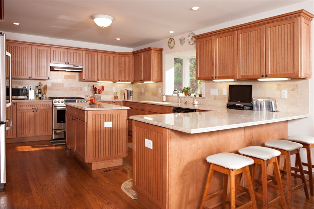 Lot 1 Marcy Road Otis, MA 01253 - Photo 14 of 15 a kitchen with stainless steel appliances granite countertop a table chairs sink refrigerator and cabinets