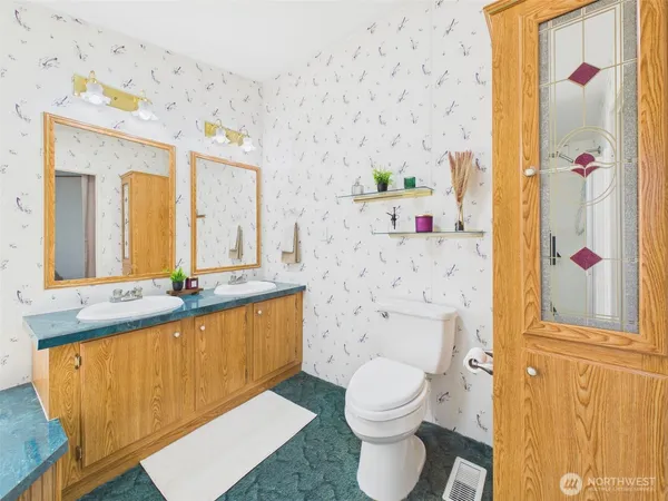 a bathroom with a sink mirror vanity and toilet