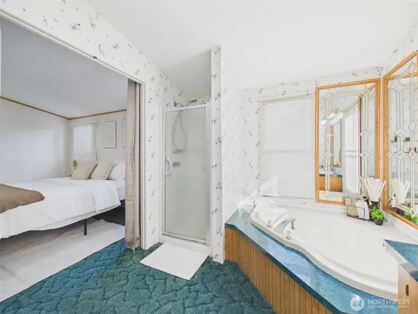 a bathroom with a tub sink and mirror