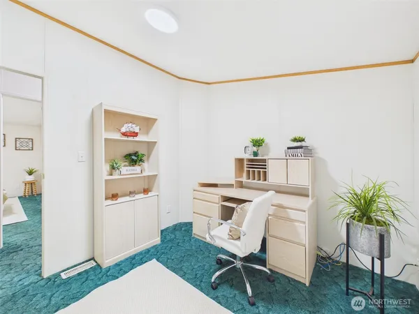 a workspace with furniture and a potted plant