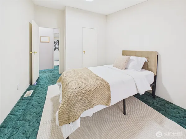 a bedroom with a bed and mirror