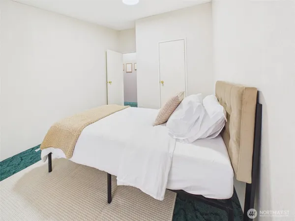 a bedroom with a bed and a chair