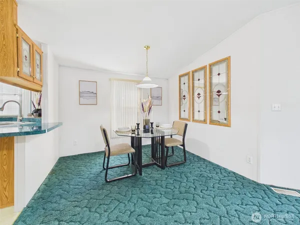 a dining room with furniture and window