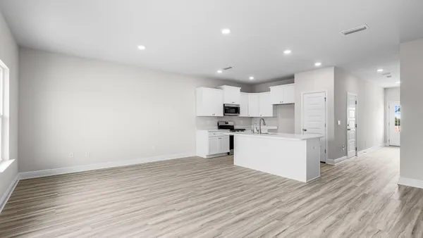 a kitchen with a sink stove and cabinets