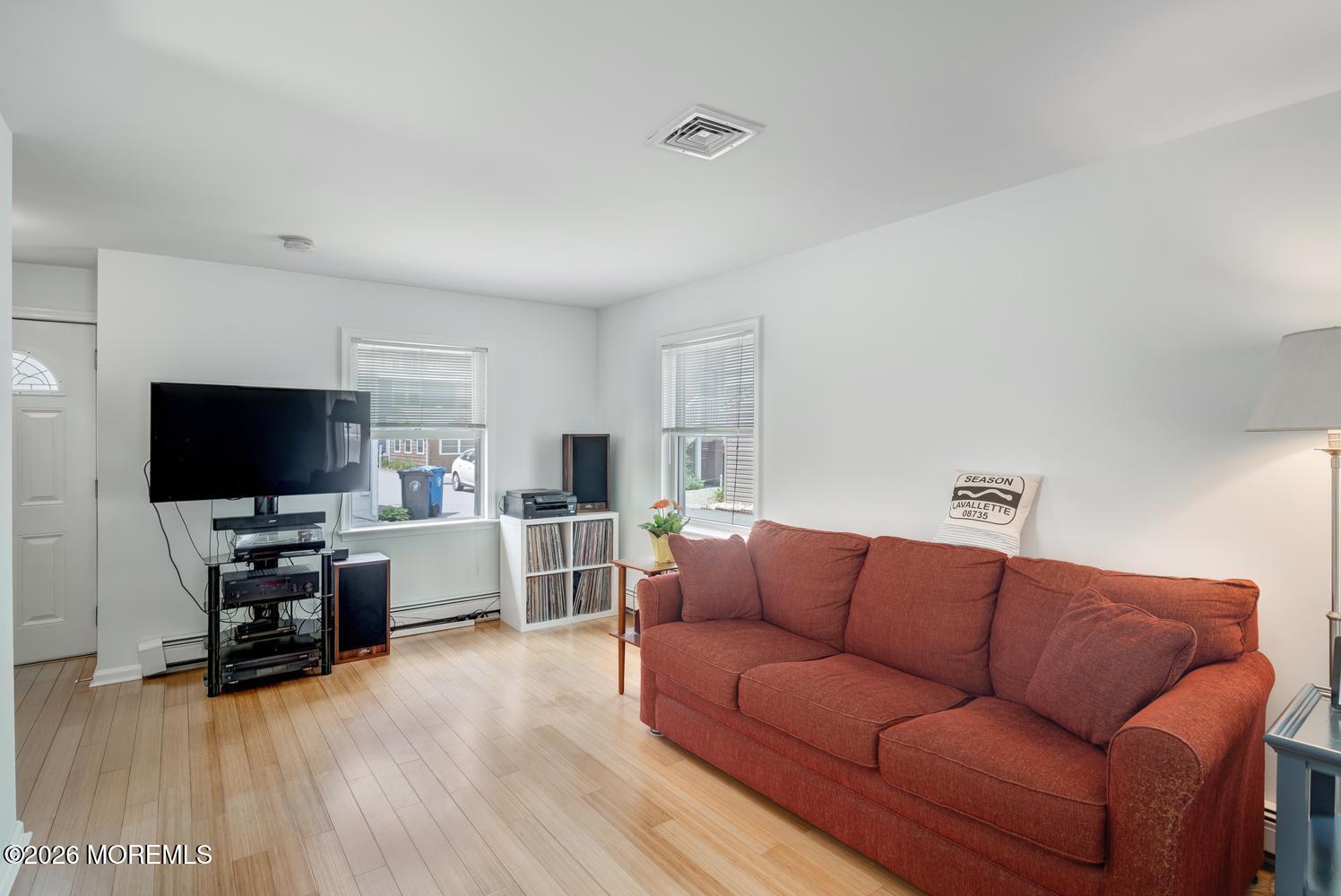 19 Shore Way Lavallette, NJ 08735 - Photo 8 of 38 a living room with furniture and a flat screen tv