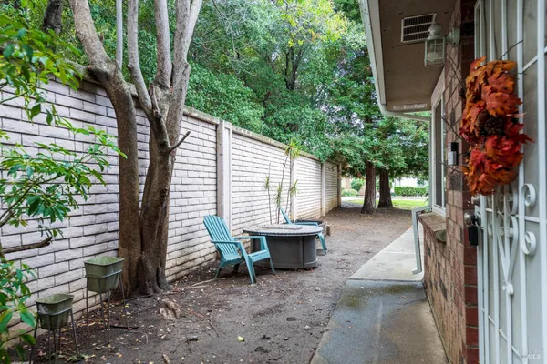 a view of a house with a backyard and trees