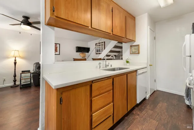 a kitchen with stainless steel appliances granite countertop a sink stove and wooden floor