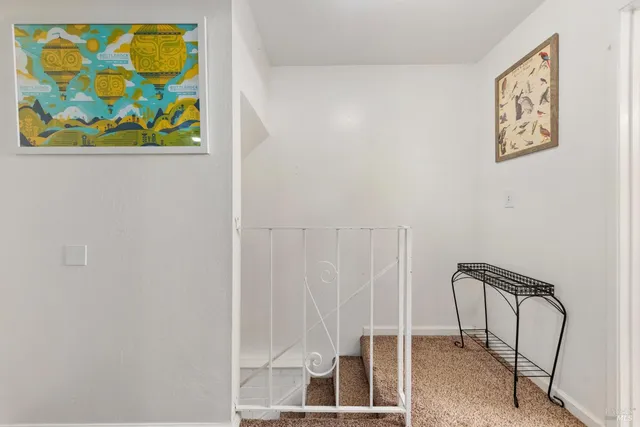 a view of a hallway with paintings on the wall
