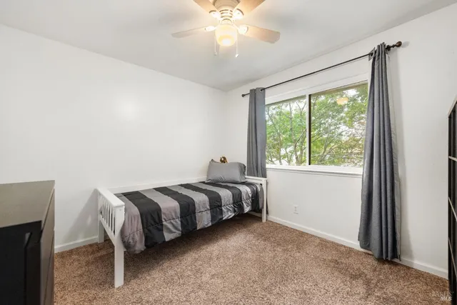 a bed room with a bed and a window