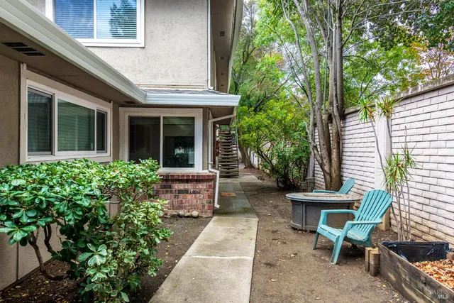 a view of a house with backyard sitting area and garden