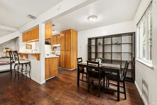 a view of a dining room with furniture and a window