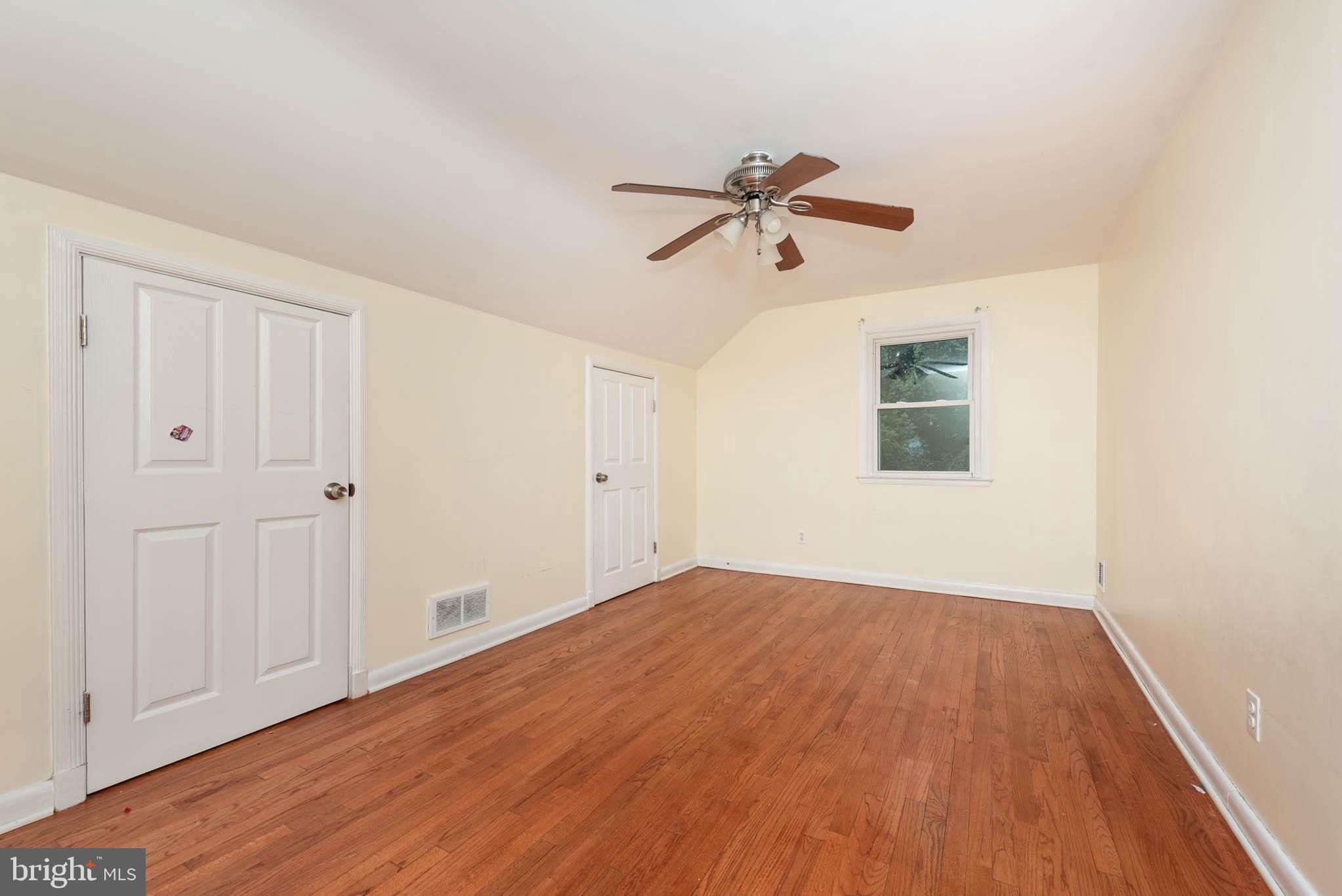 6702 Queens Ferry Road Baltimore, MD 21239 - Photo 21 of 40 a view of empty room with wooden floor and fan