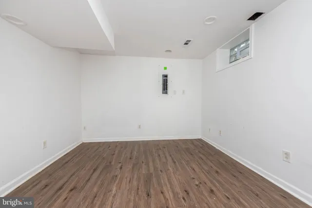 a view of a room with wooden floor