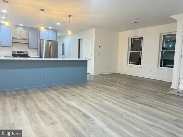 a view of kitchen and kitchen with wooden floor