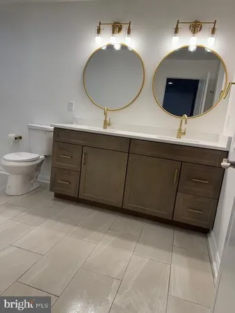 a bathroom with a double vanity sink and a mirror