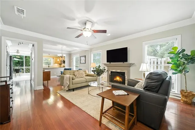 a living room with furniture a fireplace and a flat screen tv