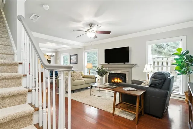 a living room with furniture a fireplace and a flat screen tv