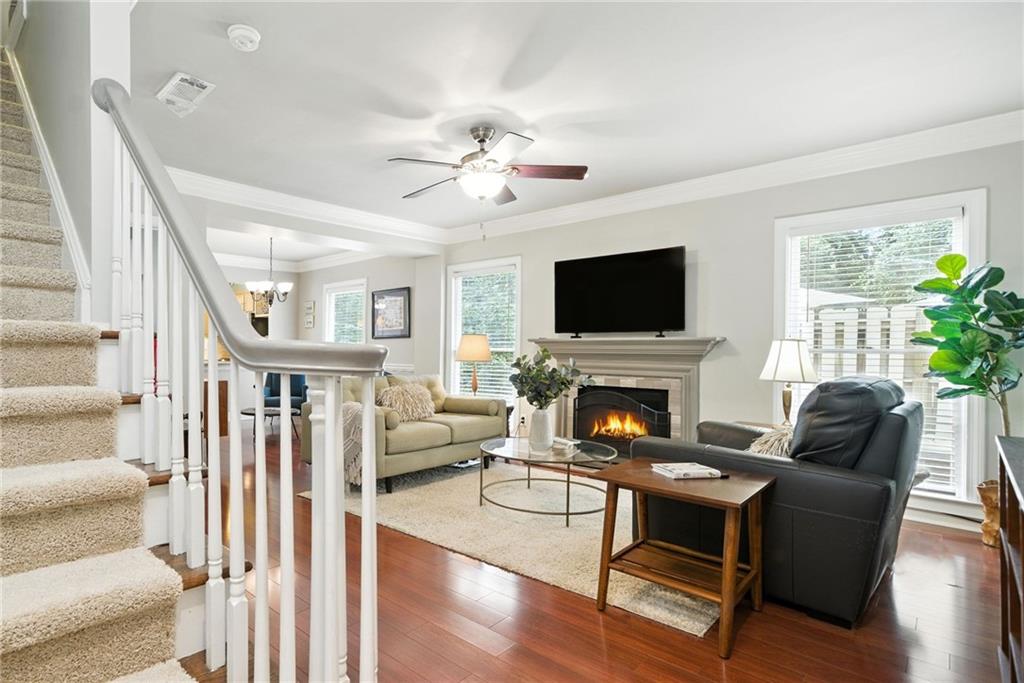 44 Mt Vernon Circle Sandy Springs, GA 30338 - Photo 12 of 27 a living room with furniture a fireplace and a flat screen tv