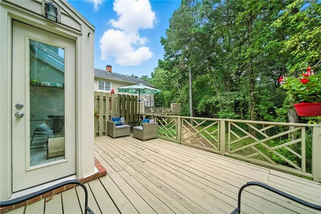 a view of balcony with wooden floor and seating space