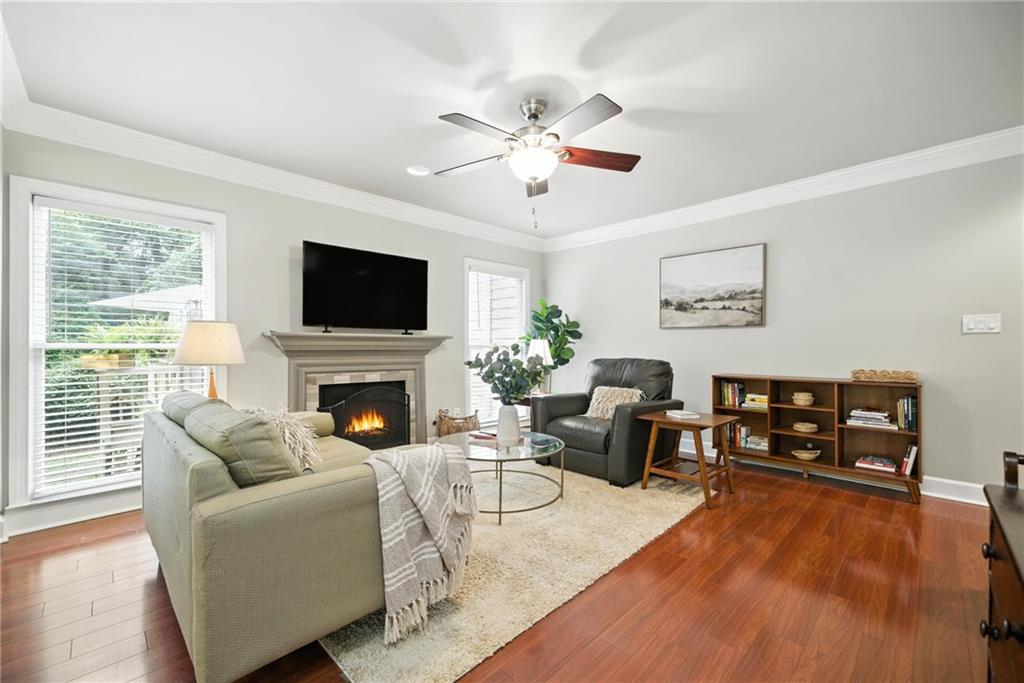 44 Mt Vernon Circle Sandy Springs, GA 30338 - Photo 4 of 27 a living room with furniture a fireplace and a flat screen tv