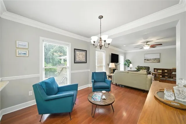 a living room with furniture chandelier and a flat screen tv