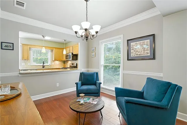 a view of a dining room with furniture window and wooden floor