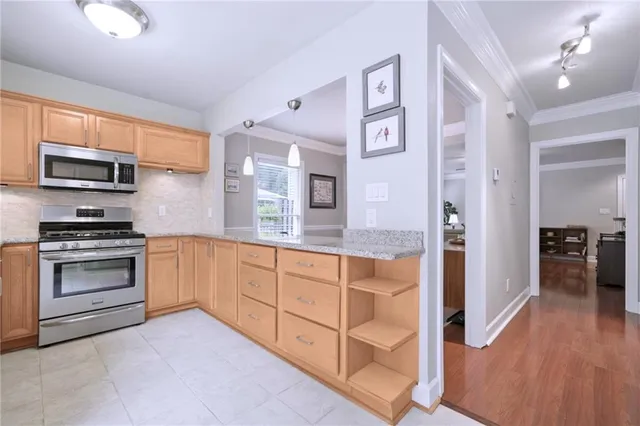 a kitchen with stainless steel appliances granite countertop a stove and a refrigerator