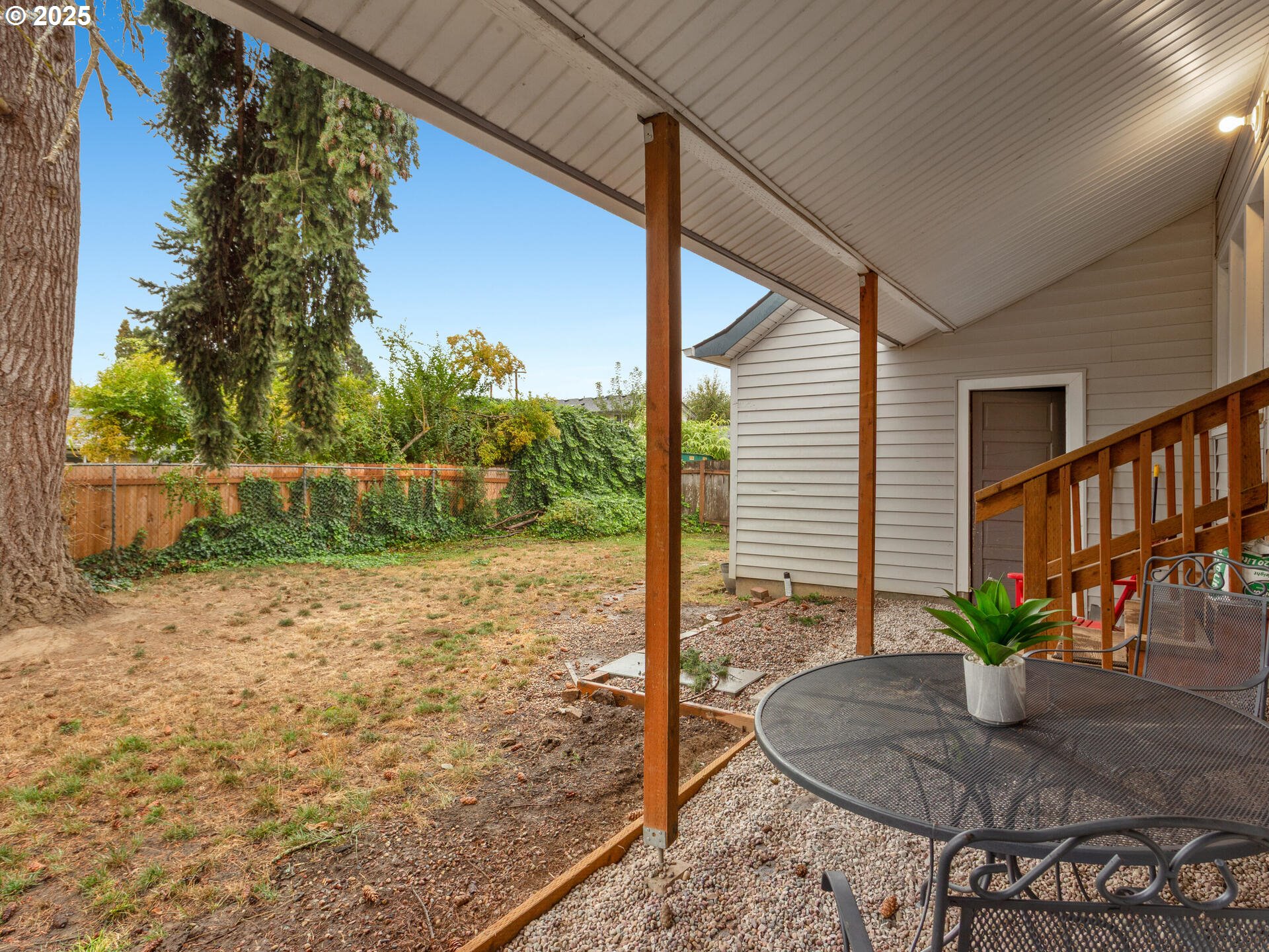 933 North Main Avenue Ridgefield, WA 98642 - Photo 38 of 42 a backyard of a house with table and chairs plants