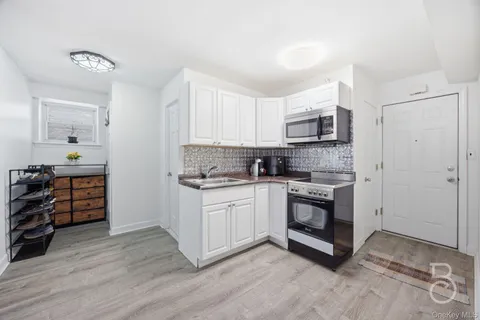 a kitchen with stainless steel appliances a stove a sink and a microwave