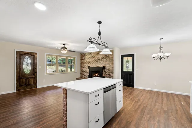 a large white kitchen with a large window