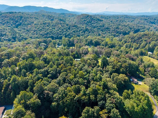 an aerial view of a houses with city view and mountain view