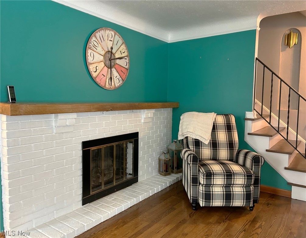 1748 Sunview Road Lyndhurst, OH 44124 - Photo 13 of 41 Living Room featuring a brick fireplace with wood mantel, and hardwood floors.