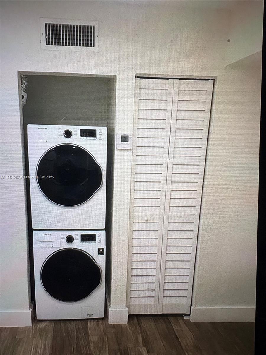 13864 Southwest 90th Avenue, Unit 108LL Miami, FL 33176 - Photo 2 of 10 a view of a hallway with washer and dryer